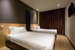 a hotel room with two beds and a television at HF Ala Sul in Porto