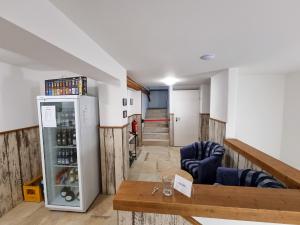 a room with a refrigerator and a table at Apartment "Storch" in Wehlenberg +15 photos
