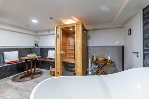 a bathroom with a shower and a table at Day SPA Streudorf in Muhr amSee