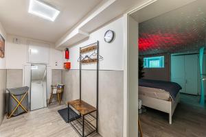 a bedroom with a bed and a refrigerator in a room at Day SPA Streudorf in Muhr amSee