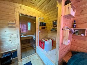 an inside view of a wooden cabin with a room at Weinbergsauna in Großweingarten +24 photos