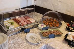 a table with meats and other food on it at Doppelzimmer 3 in Heidenheim