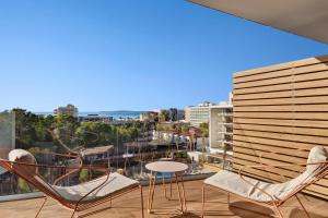 a balcony with chairs and a table and a view at Aubamar Palma Resort in Playa de Palma