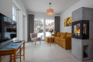a living room with a couch and a fireplace at Schwedenhaus Leevsteed in Neuhaus