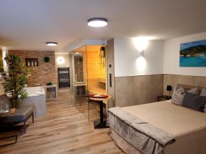 a bedroom with a large bed and a bathroom at Wellness Suite - Dream SPA in Spalt +7 photos