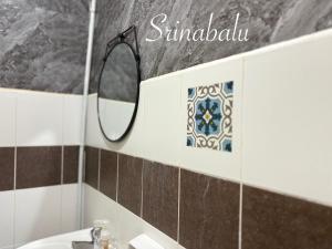 a bathroom with a mirror and a sink at Sri Nabalu Apartment Platinum Putatan in Kota Kinabalu +16 photos