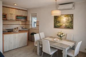 a kitchen and dining room with a table and chairs at President 034 in Arandelovac