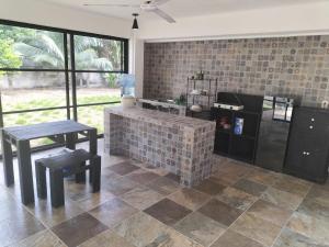 a kitchen with a counter and a table and benches at Casa Ix Milagros in Huay Pix