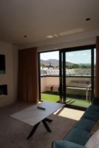 a living room with a couch and a large window at House 15 in Kenmare