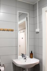 a bathroom with a sink and a mirror at Scandinavian Dream Guesthouse and Apartments in Rovaniemi +78 photos