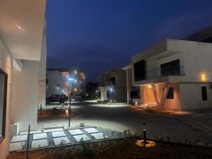 an empty street in a city at night at Luxury Executive Balcony Suite at THE HIDDEN DOMUS I Elmina Suite in Accra