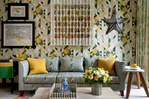 a living room with a couch and a patterned wall at Number Sixteen, Firmdale Hotels in London