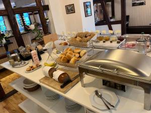 a buffet with bread and pastries on a table at Landhaus Falkenstein in Tambach-Dietharz +7 photos