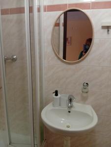 a bathroom with a sink and a mirror at Penzion Helena in Stará Lesná +22 photos