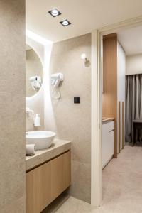 a bathroom with a sink and a mirror at Xanthia Suites in Xanthi +59 photos