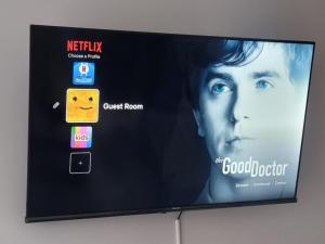 a television screen with a movie projected on it at Private Studio Suite, 24h Self Check-in in Luton