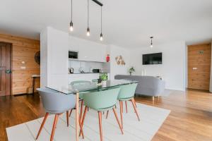 a kitchen and dining room with a glass table and chairs at GuestReady - Good Vibes in Ponta Delgada