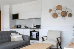 a living room with a couch and a kitchen at GuestReady - Good Vibes in Ponta Delgada