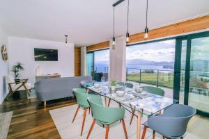 a dining room with a glass table and chairs at GuestReady - Good Vibes in Ponta Delgada +46 photos