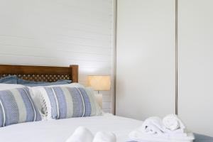 a bedroom with a bed with towels on it at GuestReady - Good Vibes in Ponta Delgada