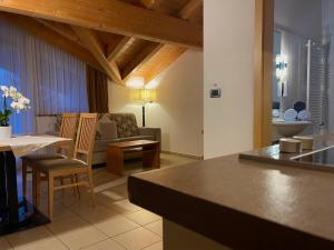 a kitchen and living room with a couch and a table at Residence Remi in Senales