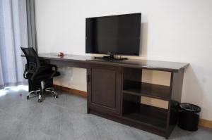 a desk with a television on top of it at Luganvilla Business Hotel and Restaurant in Luganville