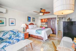 a bedroom with a bed and a couch at Islander on the Beach 249 in Kapaa +48 photos