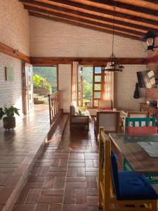 a living room with a table and chairs at Morada de las Aves in Cali