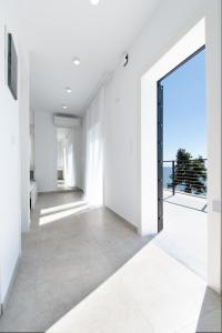 an open door in a white room with a view at Penthouse Seafront Luxury Studio in Epanomi