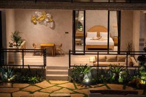 a bedroom with a bed and a couch in a room at Bella Vida Resort, Uluwatu in Uluwatu +45 photos
