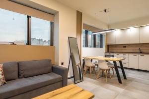 a living room with a couch and a table at Xanthia Suites in Xanthi