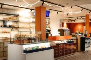a bakery with a counter with a lot of food at Scandic Go, Saaristonkatu 1 in Oulu