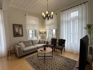 a living room with a couch and a table at Sea & Stone House in Nafpaktos