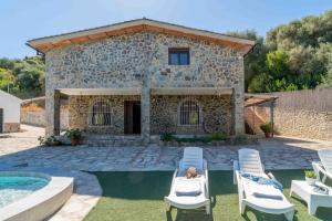 a villa with a swimming pool and a house at El Acebuchal de Ubrique in Ubrique