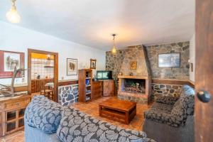 a living room with a couch and a fireplace at El Acebuchal de Ubrique in Ubrique