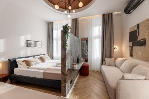 a living room with a bed and a couch at Catalog Boutique Rooms Debrecen in Debrecen