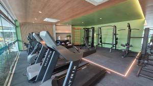 a gym with several tread machines in a room at Beach Class Verano 01 A in Ipojuca