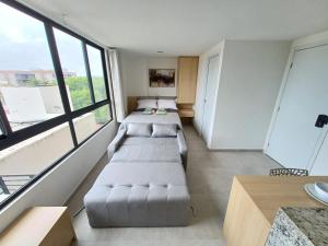 a room with two couches in a room with windows at Flat em Tamandaré - 102 - Carneiros Beach Exclusive in Tamandaré +36 photos