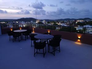 a patio with tables and chairs on a roof at Flat em Tamandaré - 102 - Carneiros Beach Exclusive in Tamandaré