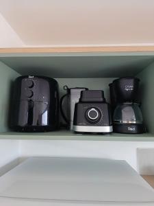 a shelf with various appliances sitting on it at Flat em Tamandaré - 102 - Carneiros Beach Exclusive in Tamandaré