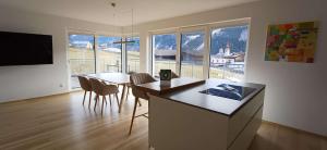 a kitchen and dining room with a table and chairs at Ferienhaus Lurger in Strassen
