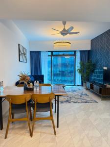 a living room with a table and a couch at IKON SUITE's E A T O N KLCC in Kuala Lumpur