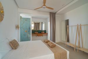a bedroom with a large white bed with a ceiling at Villa Gypsy by Aura Collection in Tindaya
