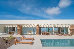 a villa with a swimming pool and a resort at Villa Gypsy by Aura Collection in Tindaya