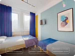 a hotel room with two beds and a window at Bello ApartHostel Private Rooms in Warsaw