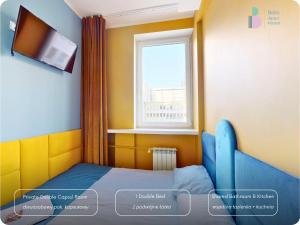 a small room with a bed and a window at Bello ApartHostel Private Rooms in Warsaw