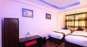 Rúm í herbergi á Hotel Gallery Nepal