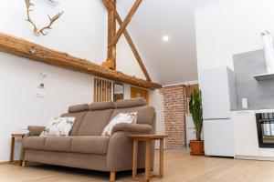 a living room with a couch and a table at Timeless Barn in Ljubljana +24 photos