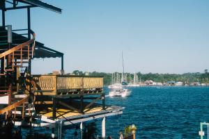 a dock on a body of water with a boat at Klika Bocas del Toro in Bocas Town