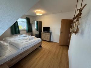 a bedroom with a bed and a television in it at Ferienhaus Windberg in Sassnitz